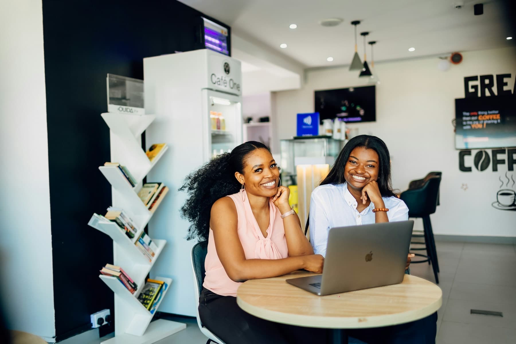 Two entrepreneurs talking around a laptop